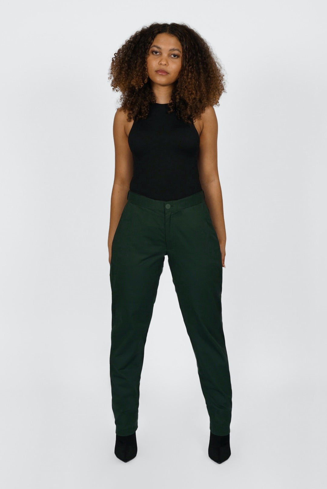 The Flex Waist Pant by Aam is a chic, cotton trouser with a hidden expandable waistband that provides 2-3" of stretch at the waist and a comfortable fit - even on your off days. It is made from a breathable, 98% organic cotton with 2% stretch and is fully machine washable. The pant also has a 4" hem which makes it easy to lengthen or cuff, as needed. The Flex Waist Pant comes in two colors - forest green (pictured here) and navy blue.