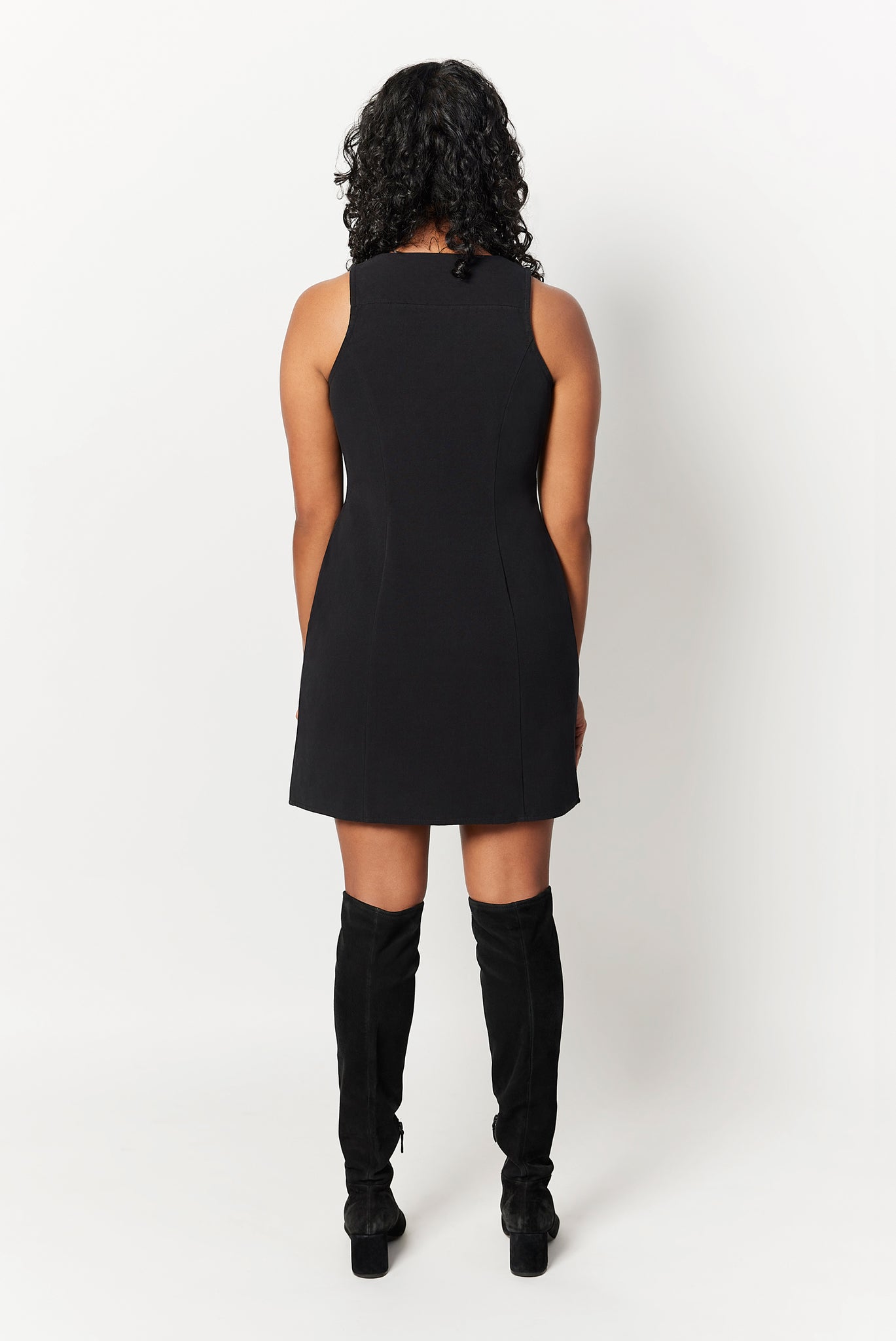 The Everywhere Dress is expertly constructed to slim through the waist with a roomy fit for pear and hourglass shapes There is no awkward bunching or pulling at the waist and hips. Shown here is the back view of The Everywhere Dress in Black.