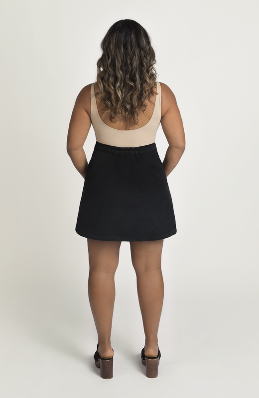 The Cord Mini Skirt by Aam The Label has a redesigned waist-to-hip ratio that is made for women with pear and hourglass shapes. Shown here is the full back view in classic black.