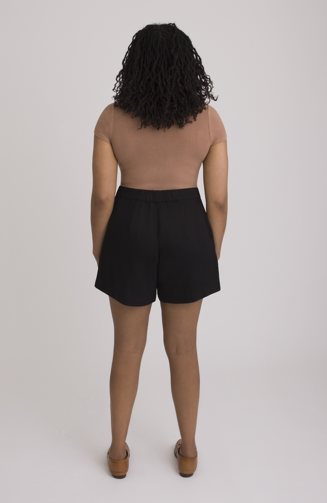 The Anywhere Short sits snug at the high waist with a roomy fit for full hips. Shown here is the back view in classic black.