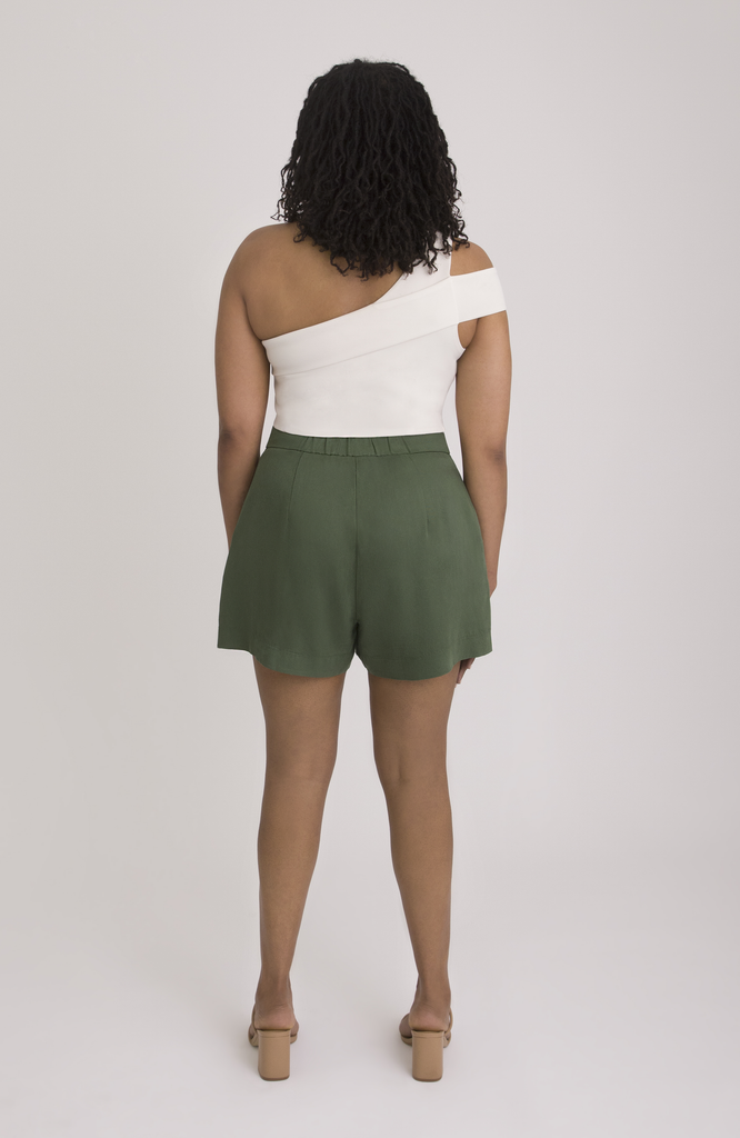 The Anywhere Short sits snug at the high waist with a roomy fit for full hips. Shown here is the back view in forest green.