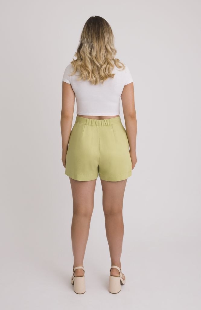 The Anywhere Short sits snug at the high waist with a roomy fit for full hips. Shown here is the back view in a fresh pear green.