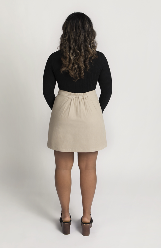 The Cord Mini Skirt by Aam The Label has a redesigned waist-to-hip ratio that is made for women with pear and hourglass shapes. Shown here is the full back view in a gorgeous, neutral, off-white.