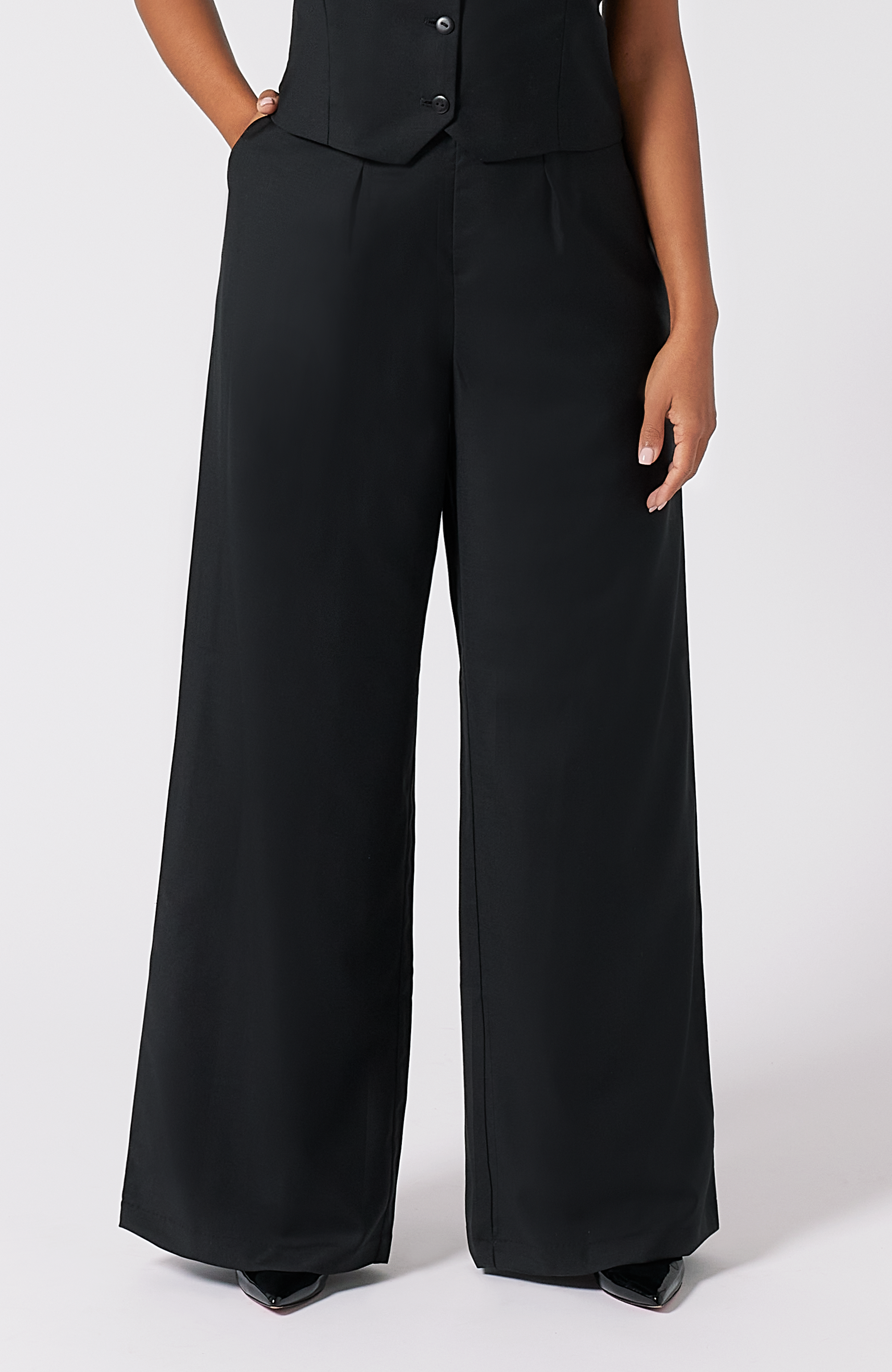 The Wool Wide Leg Pant by Aam The Label is designed for full hips and thighs. It sits high on the waist with a roomy fit for curvy hips. Made from a warm merino wool and fully lined with organic cotton. It is shown here in classic black.