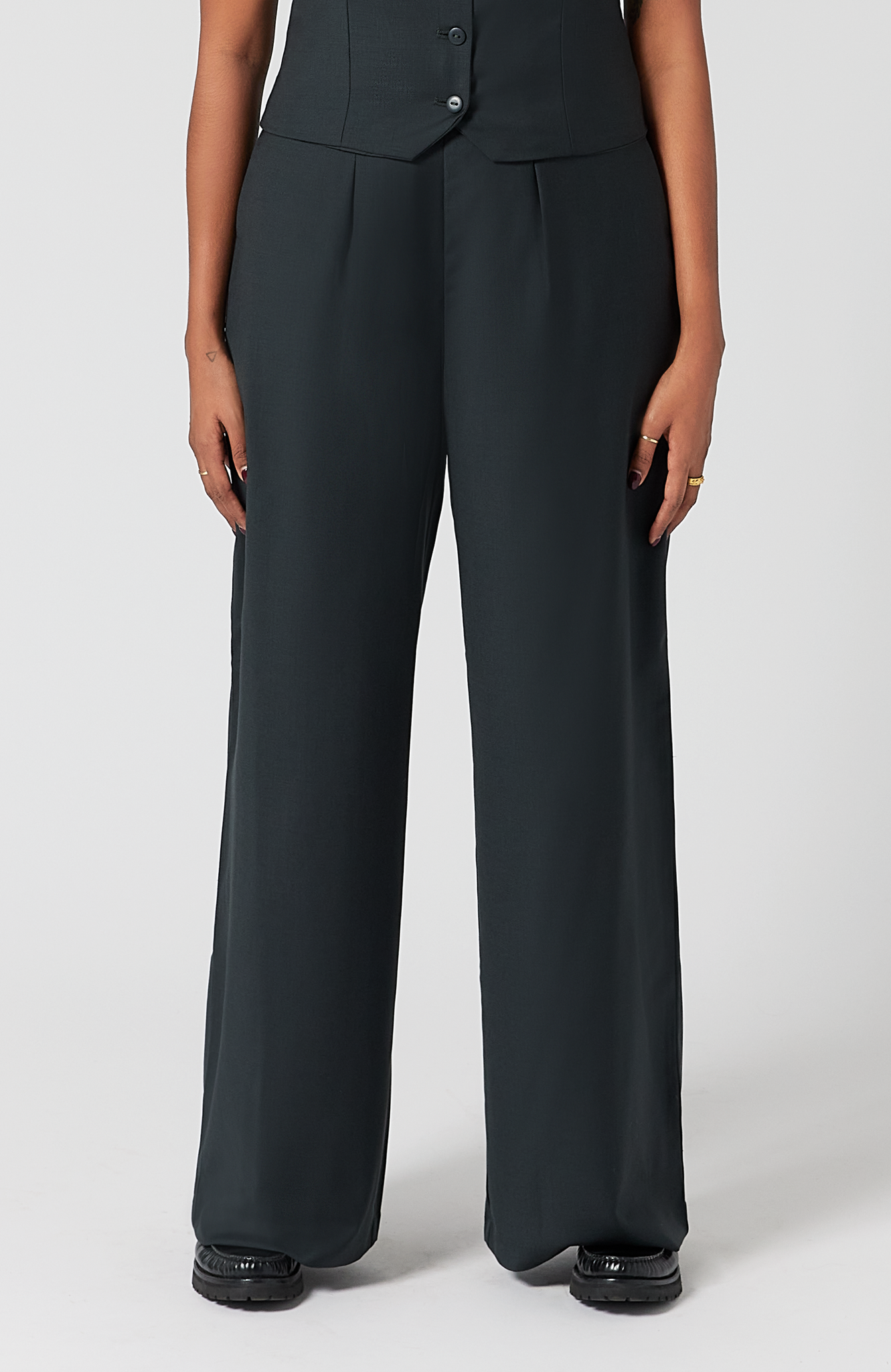 The Wool Wide Leg Pant by Aam The Label is designed for full hips and thighs. It sits high on the waist with a roomy fit for curvy hips. Made from a warm merino wool and fully lined with organic cotton. It is shown here in a classic charcoal.