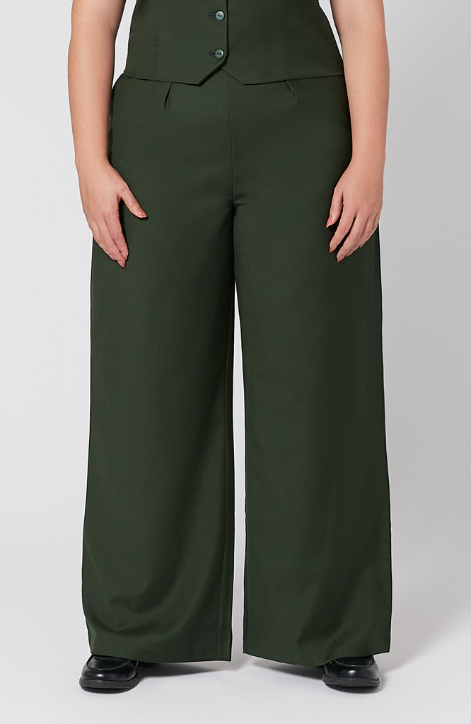 The Wool Wide Leg Pant by Aam The Label is designed for full hips and thighs. It sits high on the waist with a roomy fit for curvy hips. Made from a warm merino wool and fully lined with organic cotton. It is shown here in a gorgeous, deep green shade.