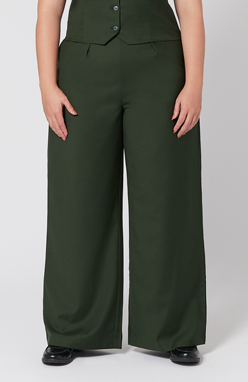 The Wool Wide Leg Pant by Aam The Label is designed for full hips and thighs. It sits high on the waist with a roomy fit for curvy hips. Made from a warm merino wool and fully lined with organic cotton. It is shown here in a gorgeous, deep green shade.