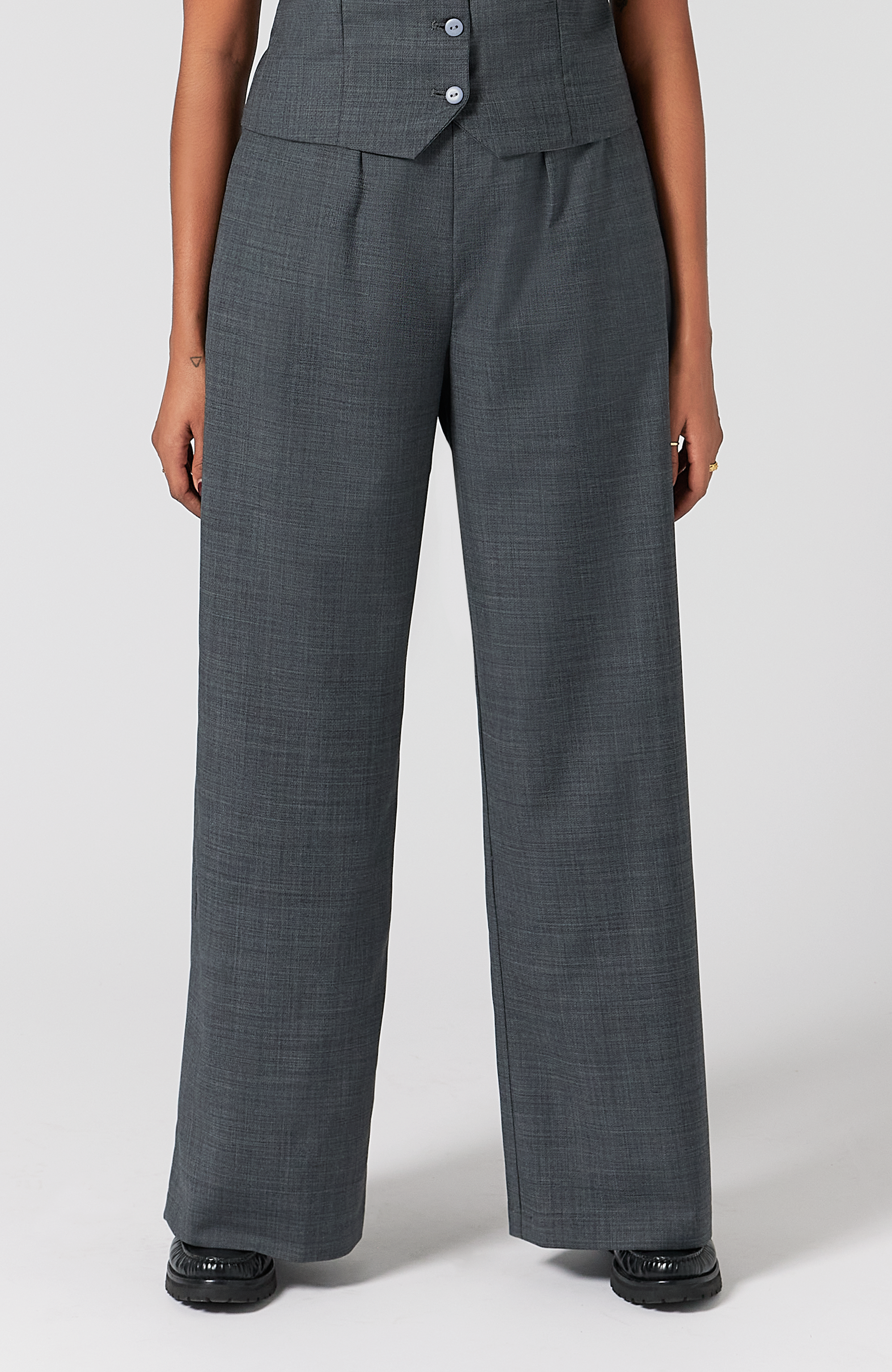 The Wool Wide Leg Pant by Aam The Label is designed for full hips and thighs. It sits high on the waist with a roomy fit for curvy hips. Made from a warm merino wool and fully lined with organic cotton. It is shown here in a classic grey.