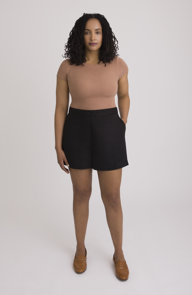 The Anywhere Short is made for full hips and thighs. It is high waisted with a small back elastic for comfort and has a roomy fit through the seat for curvy bottom shapes. Shown here is the front view on the short in classic black.