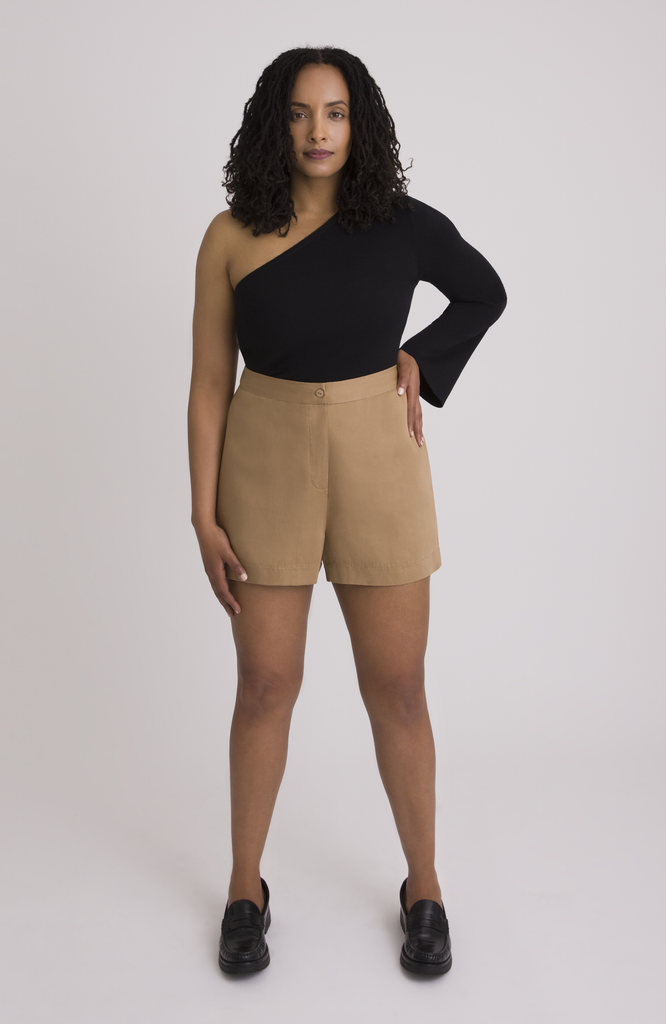 The Anywhere Short is made for full hips and thighs. It is high waisted with a small back elastic for comfort and has a roomy fit through the seat for curvy bottom shapes. Shown here is the front view on the short in classic tan.