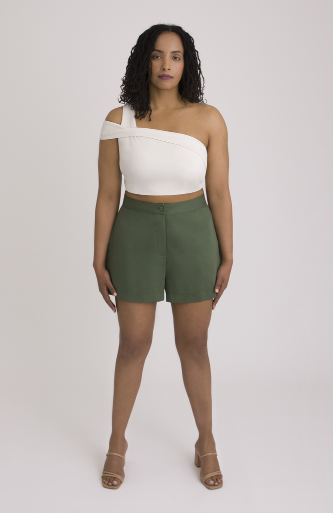 The Anywhere Short is made for full hips and thighs. It is high waisted with a small back elastic for comfort and has a roomy fit through the seat for curvy bottom shapes. Shown here is the front view on the short in forest green.