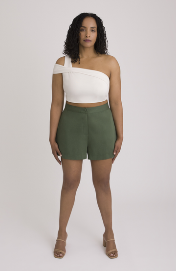 The Anywhere Short is made for full hips and thighs. It is high waisted with a small back elastic for comfort and has a roomy fit through the seat for curvy bottom shapes. Shown here is the front view on the short in forest green.