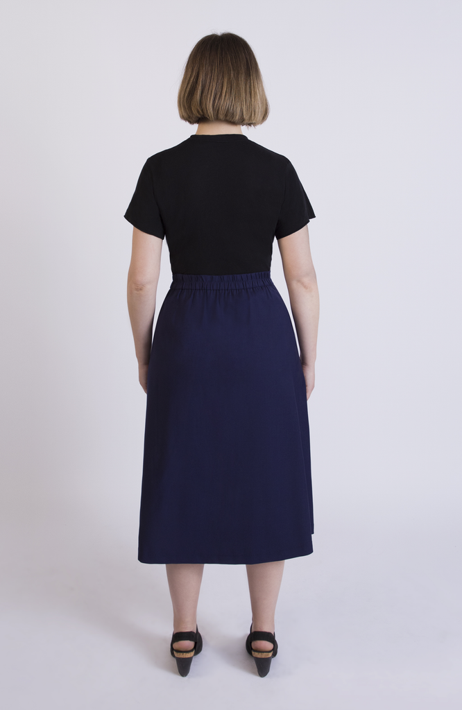 The Wool Midi Skirt by Aam The Label has a discreet back elastic that provides comfort at the waist and eliminates waist gaps. Shown here in classic Navy.