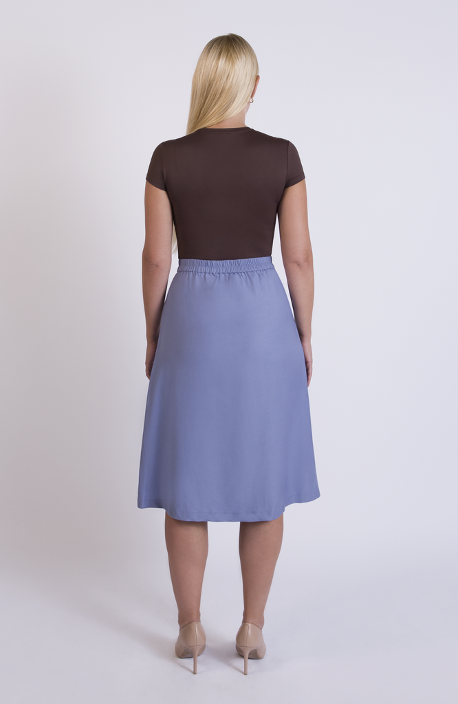 The Wool Midi Skirt by Aam The Label has a discreet back elastic that provides comfort at the waist and eliminates waist gaps. Shown here in the shade Sky.