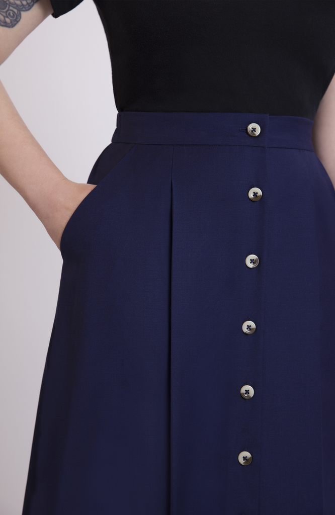 The skirt features deep, functional pockets that comfortably fit your whole hand, a small wallet and most smartphones. Shown here in Navy.
