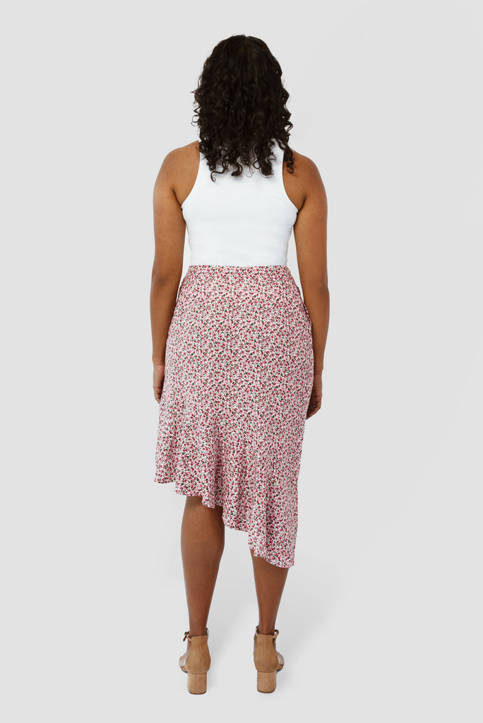 The Cascade Skirt by Aam The Label is designed to sit snug at the waist with more room for full hips and thighs. In this image you can see the back view of the pink skirt.
