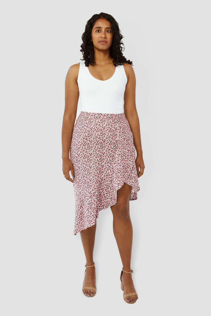 The Cascade Skirt by Aam The Label is a universally flattering midi skirt. It sits high at the waist with more room for full hips and thighs. Shown here is the front view on a model who is 5'7" with 2" heels. She is wearing a size Small in the color pink.