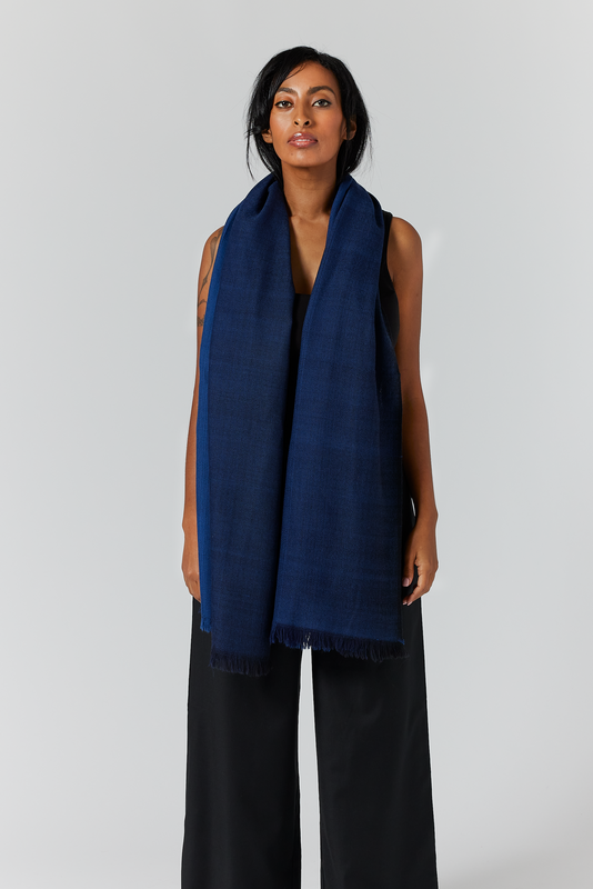 The Aurora Wrap can be worn as a chunky scarf, or wrapped once more for a more compact look. It is versatile and easy to maneuver. Here it is shown in the midnight hue.