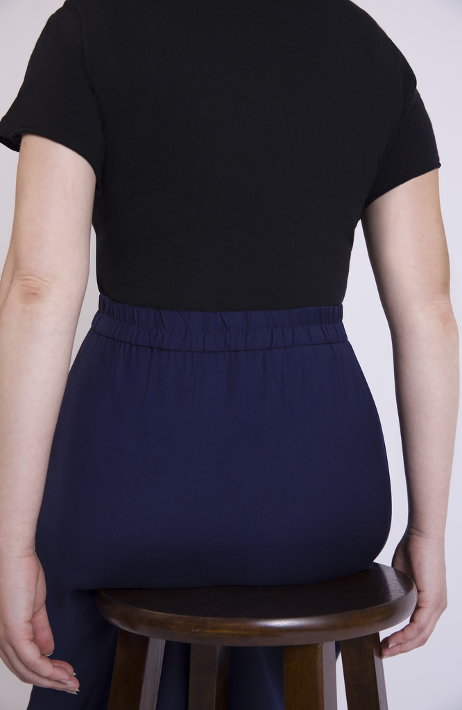 Designed with a waist-to-hip ratio for pear and hourglass shapes, the skirt sits snug at the high waist with plenty of room for your hips. There are no waist gaps. The Wool Midi Skirt is shown here in Navy.