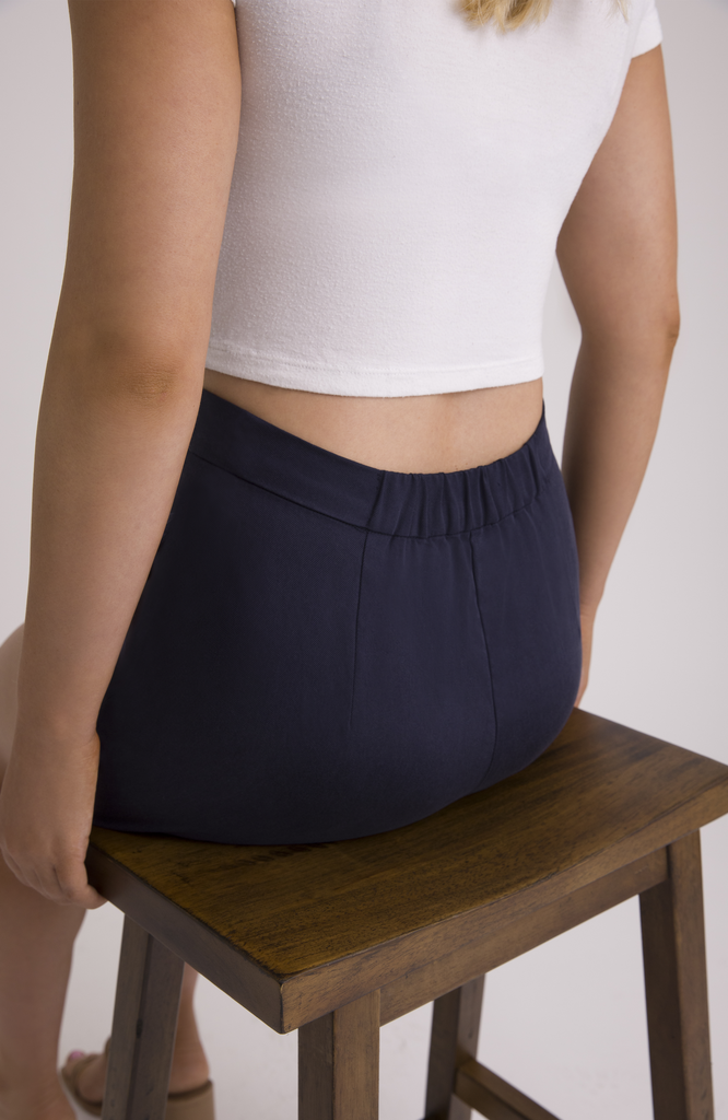 A small center back elastic provides flexibility and comfort at the waist, achieving a “just right” fit and eliminating waist gaps. Shown here in classic navy.