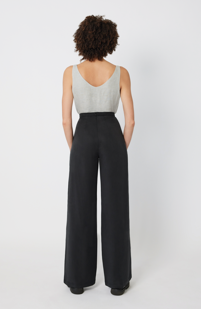 The Tall Wide Leg Pant sits snug at the high waist with a roomy fit through the hips and thighs. It features a long, hidden back zipper for ease of wear and a snatched fit through the waist, completely eliminating waist gaps. It’s shown here in a classic washed black color.