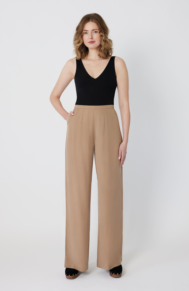 The Tall Wide Leg Pant by Aam The Label is made for women with full hips and thighs. Featuring a 34" inseam, this bestselling style is perfect for tall women looking for a true full length trouser with exceptional fit. It's shown here in a desert beige color.