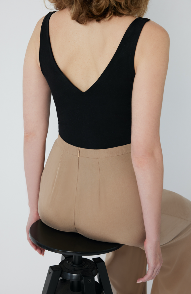 The Tall Wide Leg Pant is designed with a waist-to-hip ratio specifically for pear and hourglass shapes, eliminating waist gaps. It’s shown here in a desert beige color.