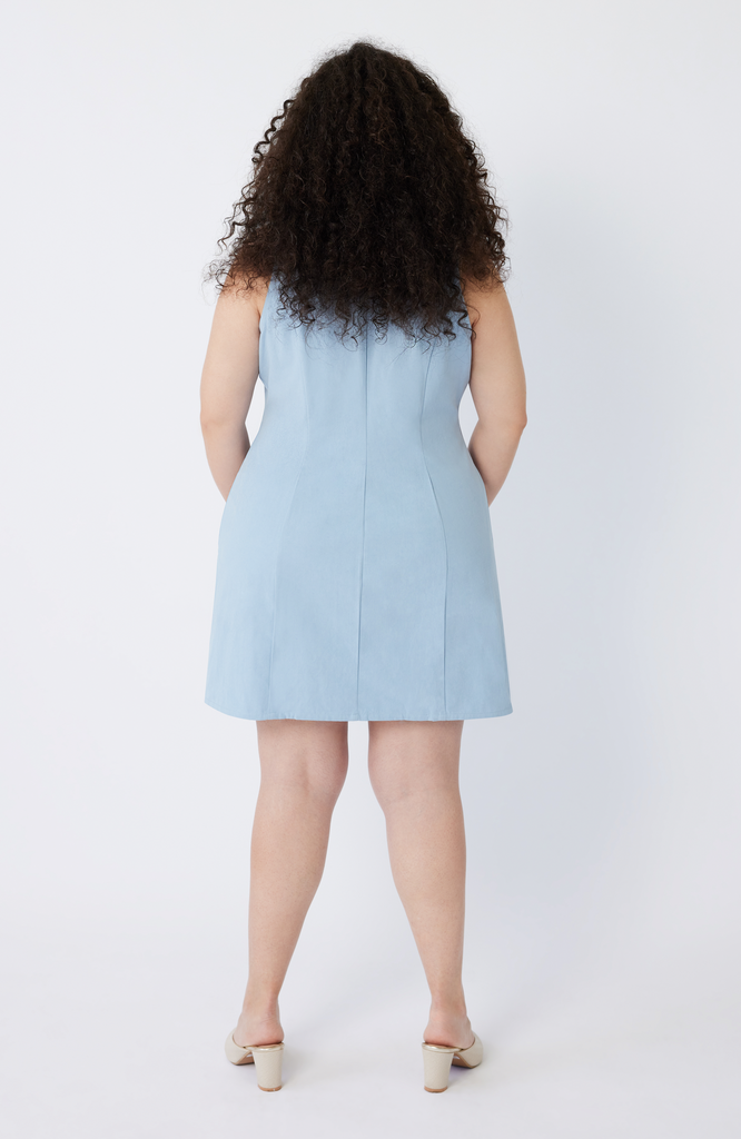 The Everywhere Dress is expertly constructed to slim through the waist with a roomy fit for pear and hourglass shapes There is no awkward bunching or pulling at the waist and hips. Shown here is the back view of The Everywhere Dress in sky blue.