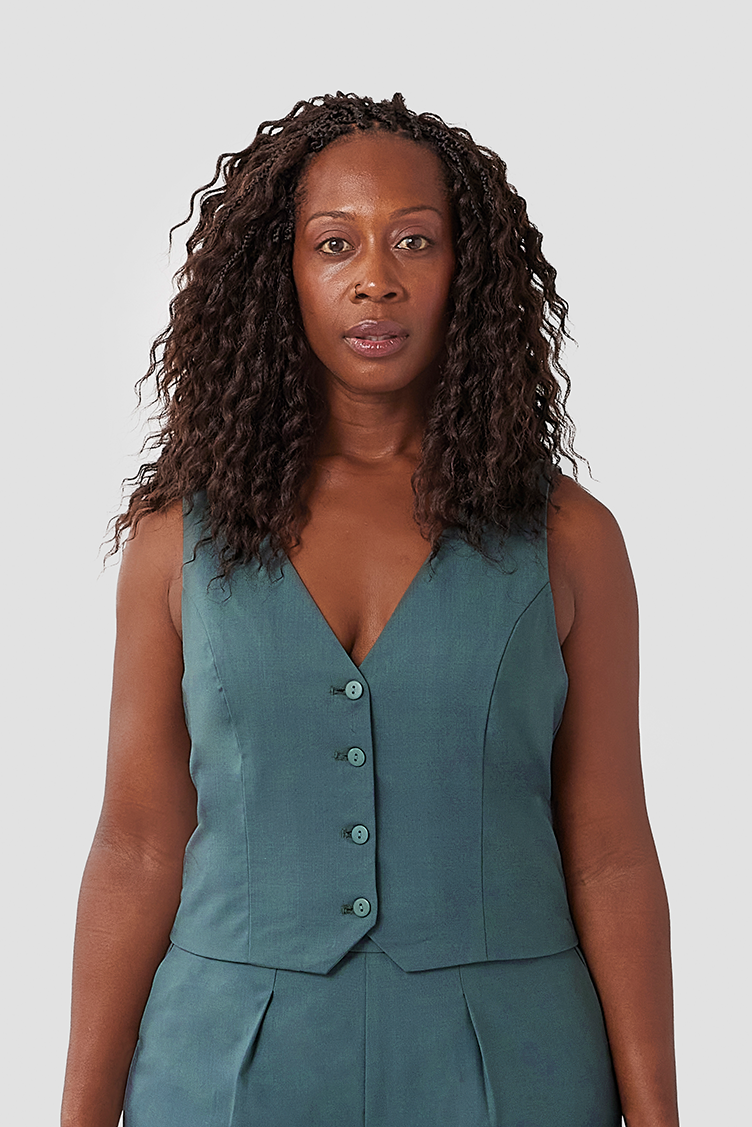 The Wool Vest by Aam is a chic, cropped vest that pairs perfectly with high waisted trousers. The vest is made from a warm, 96% wool with 4% elastane and is fully lined with organic cotton for a smooth finish on the skin. Shown here is a close-up of the vest in a gorgeous teal grey color.