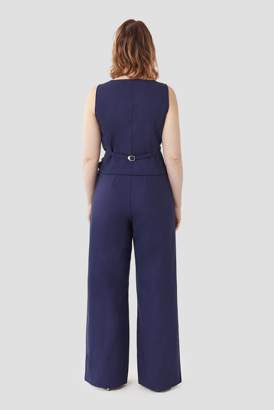 This image shows the full back length view of The Wool Wide Leg Pant by Aam. It has a snug fit at the high waist with a boho, flowy fit through the hips and thighs. The pants are made from 96% wool with 4% stretch and are fully lined with cotton for a smooth finish on the skin.