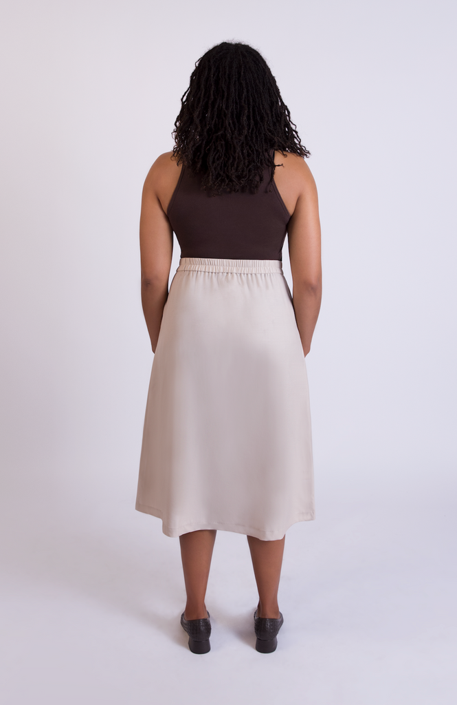 The Wool Midi Skirt by Aam The Label has a discreet back elastic that provides comfort at the waist and eliminates waist gaps. Shown here in the shade Oat.