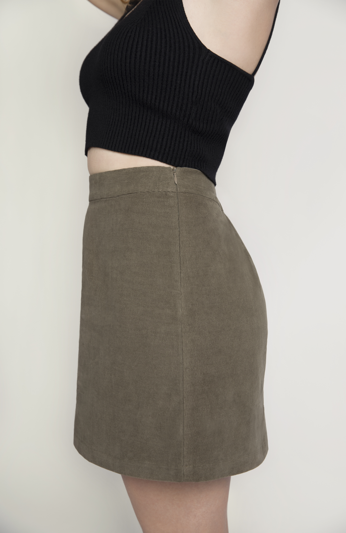 The skirt features hidden zipper closure for a seamless finish, shown here in a gorgeous, neutral moss green shade.