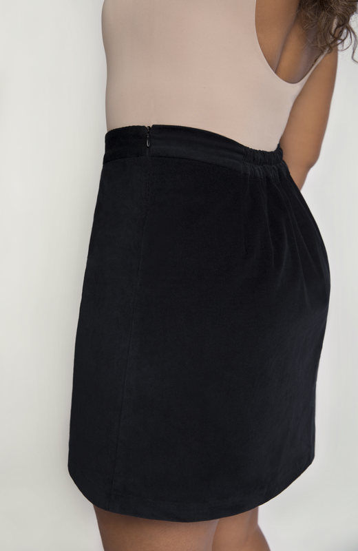 The skirt features hidden zipper closure for a seamless finish, shown here in classic black.