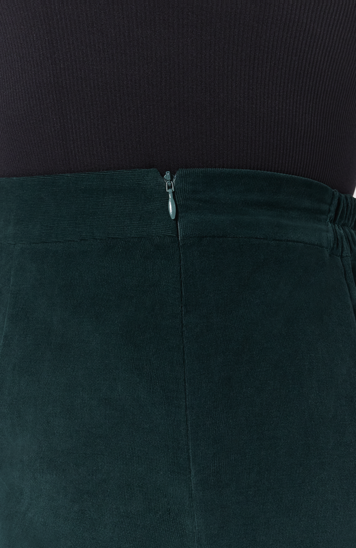 The Cord Mini skirt has hidden zipper closure for ease of wear and a seamless finish. Shown here in a tone on tone, deep, forest green shade.