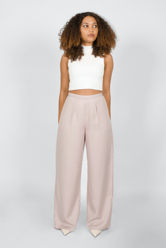 The Wide Leg Pant by Aam is made for women with full hips and thighs. It has a waist nipping rise, large pockets and a chic, boho fit that drapes beautifully on fuller hips. The pant is shown with a front view here. It comes in 2 colors, mauve and black.