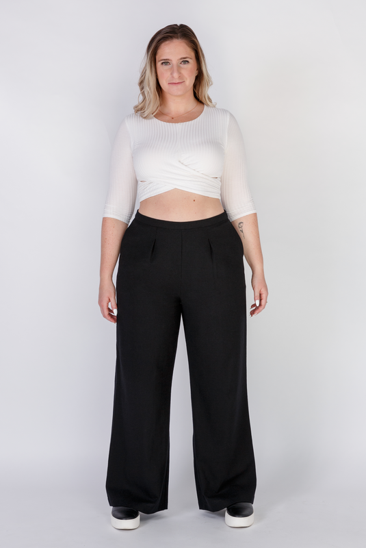 The Limited Edition Wool Wide Leg Pant by Aam is made for women with full hips and thighs. It has a waist nipping rise, large pockets and a chic, boho fit that drapes beautifully on fuller hips. The pant is shown with a front view here. It comes in two colors - black (pictured here) and grey and is made from butter-soft 97% wool and 3% stretch.