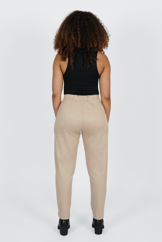 The Crop Pant by Aam is a relaxed, cotton trouser designed for women with full hips and thighs. It's made from a butter-soft, 98% organic cotton with 2% stretch. Big pockets allow you to comfortably slide your hands or phone, and a small back elastic (pictured here) provides comfort at the waist. The Crop Pant comes in two colors - beige and black. 
