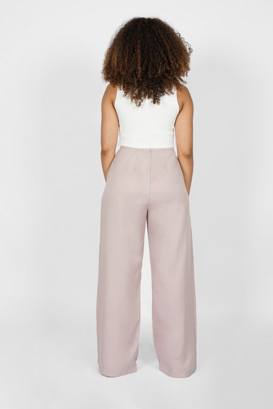 The Wide Leg Pant by Aam is made for women with full hips and thighs. This is the back view of the pant, which shows the fit at the waist, hip and thigh. The pant comes in two colors - mauve (pictured here) and black.